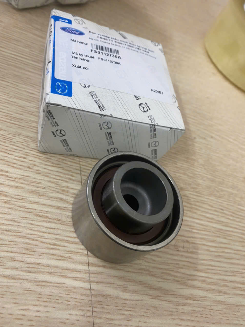 Bi tỳ curoa cam Ford Laser 1.8, bi tỳ đai cam Laser FS0112730A